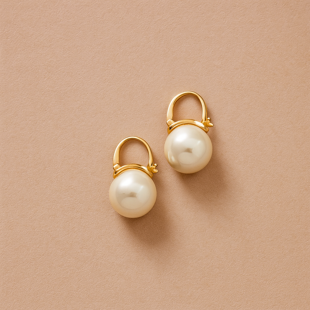 Classic Pearl Drop Earrings with gold hooks on a beige background